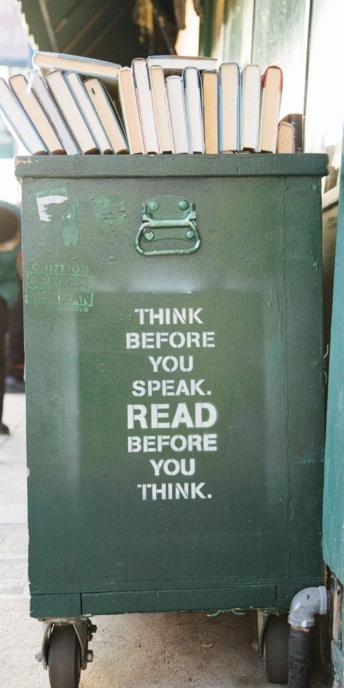 books over trolly bin with caption "Think before you speak. Read before you think."