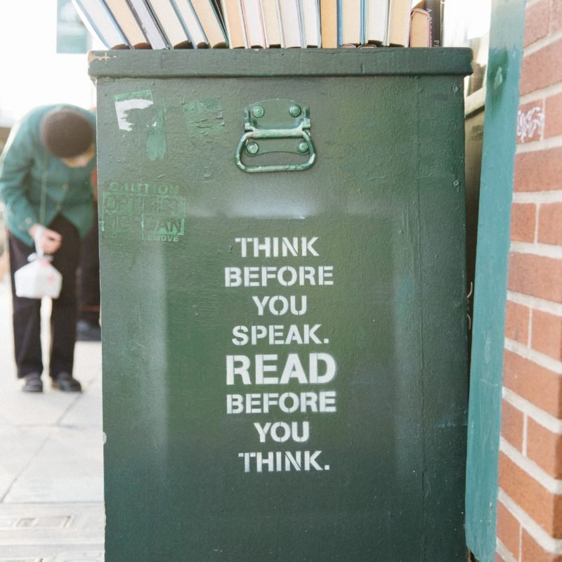 books over trolly bin with caption "Think before you speak. Read before you think."